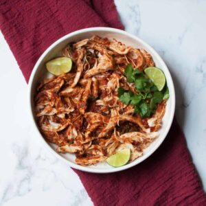 Crockpot Cilantro Lime Chicken Tacos meat with limes and cilantro