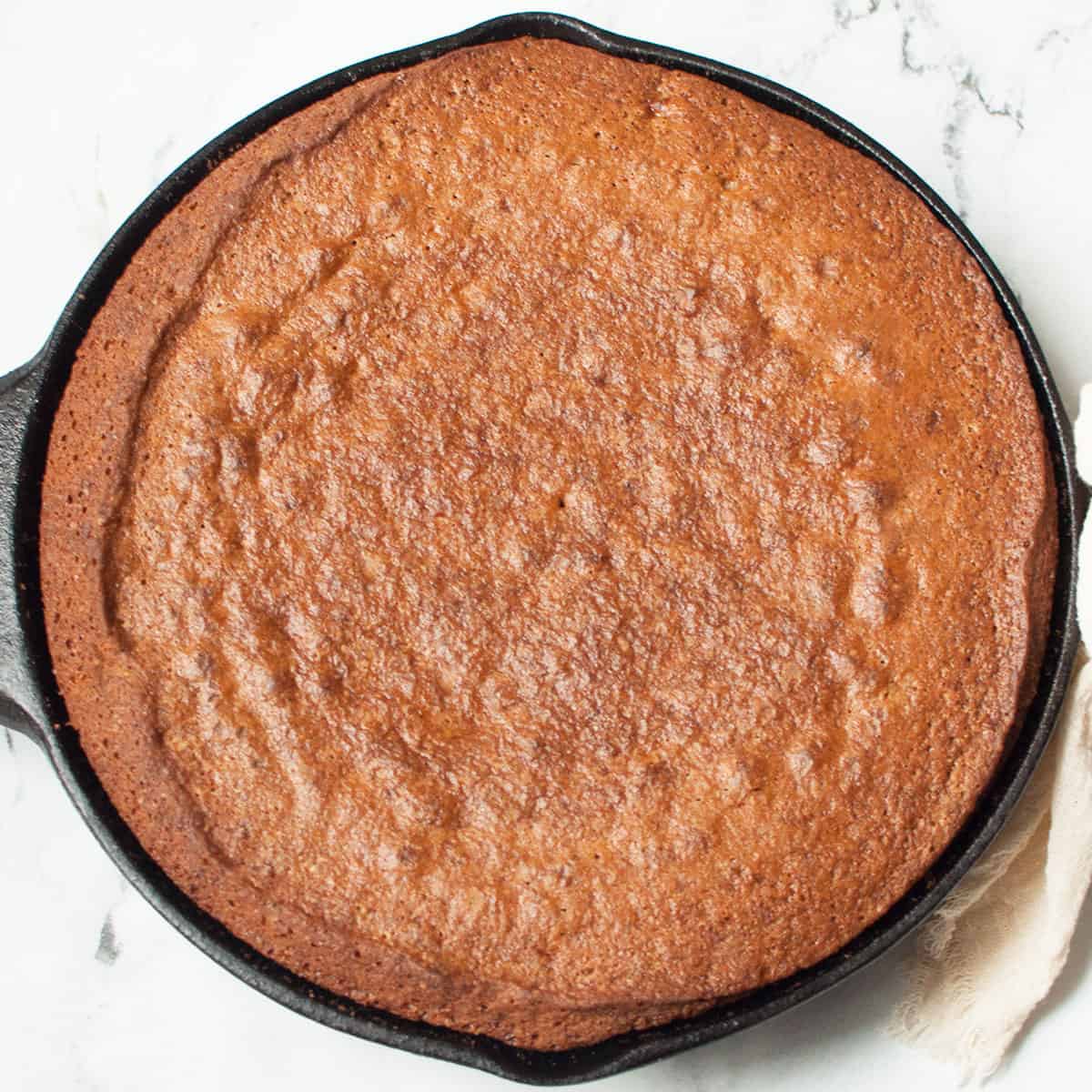 Cast Iron Skillet Banana Bread on a marble background.