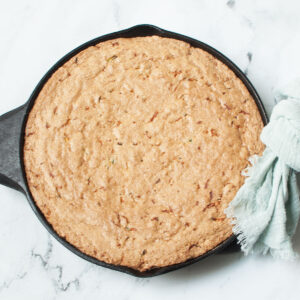 Cast Iron Skillet Zucchini Bread on a marble background.