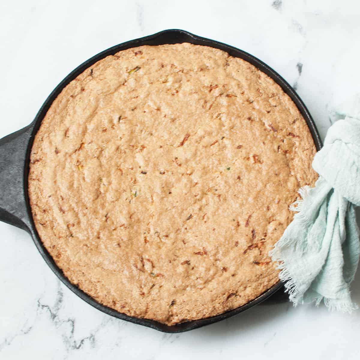 Cast Iron Skillet Zucchini Bread on a marble background.