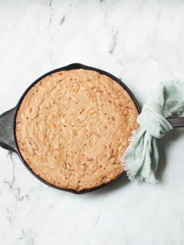 Cast Iron Skillet Zucchini Bread on a marble background.