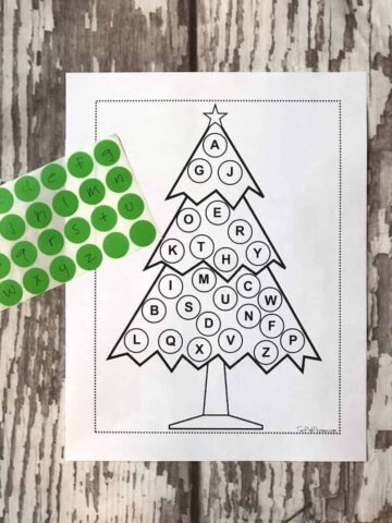 Christmas Alphabet Activity printed out with dot stickers labeled with the alphabet