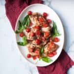 Crockpot Bruschetta Chicken on a white plate with a red linen