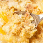 Cake Mix Peach Cobbler being scooped with a spoon.