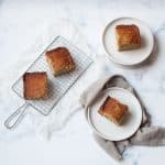 banana bread slices on a metal rack and white plates