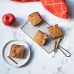 Sourdough Apple Cake slices with an apple and cinnamon sticks