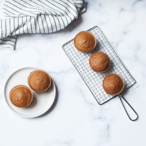 sourdough pumpkin muffins on a metal rack and a white plate