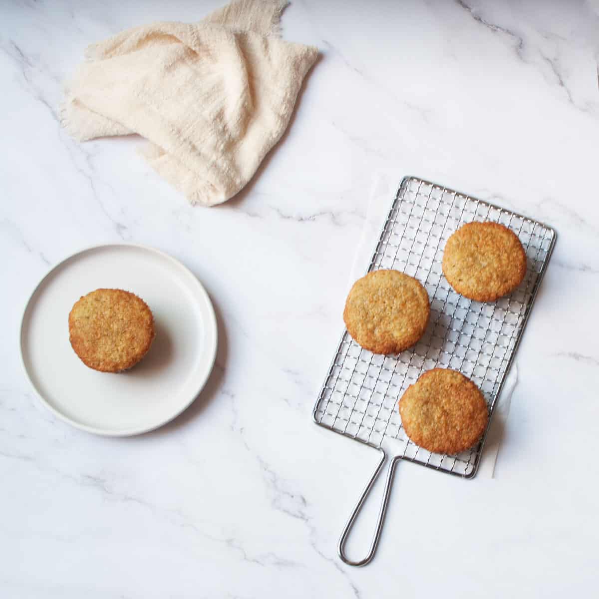 Banana Cardamom Muffins on a metal grater and white plate