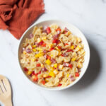 Italian Bow Tie Pasta Salad with an orange linen beside it