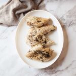 Italian herb chicken on a white plate
