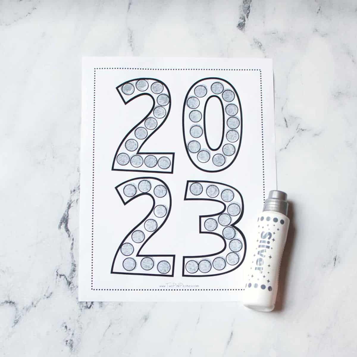2023 dot marker page with a dot marker beside it. It has been dotted in silver