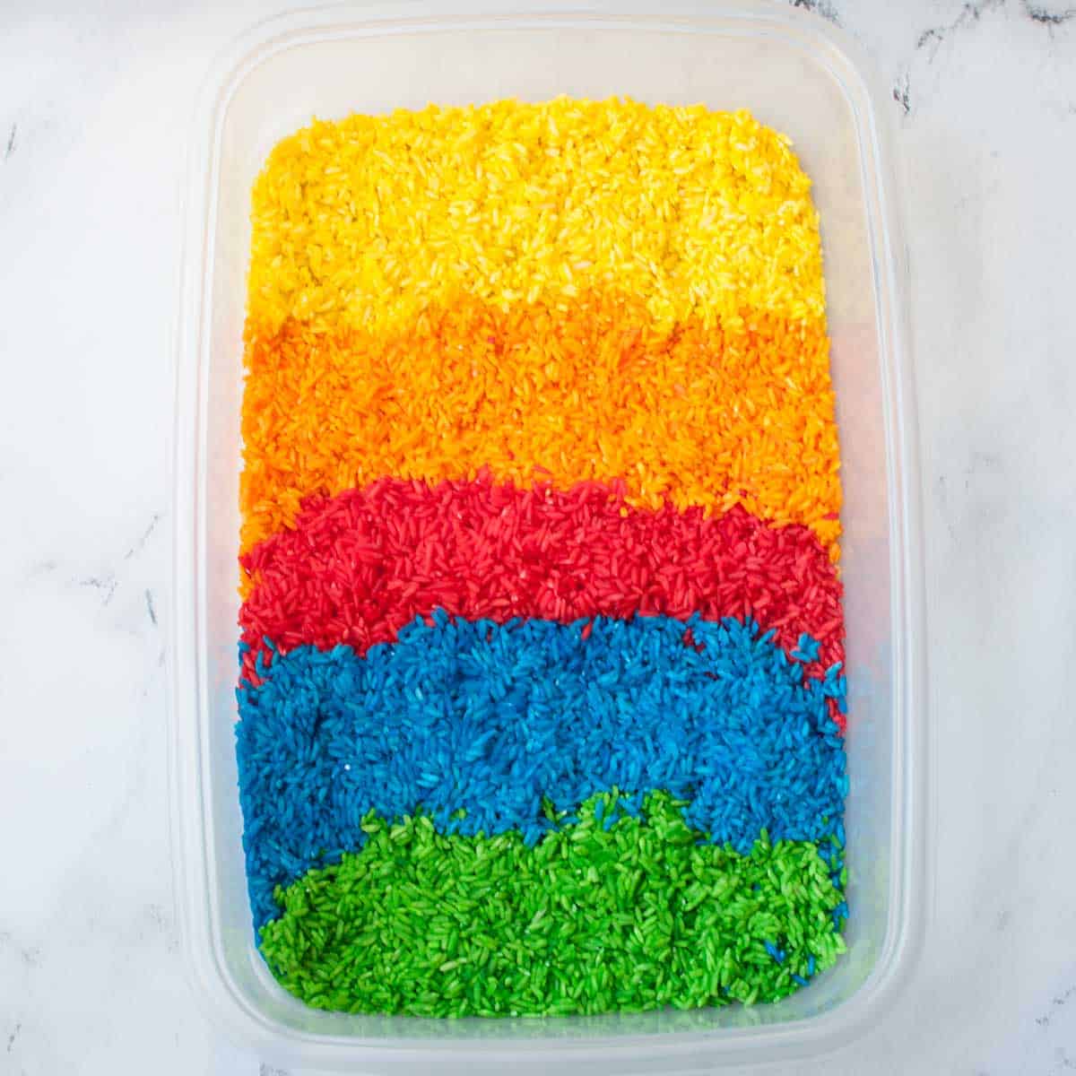 rice that has been dyed yellow, orange, red, blue, and green