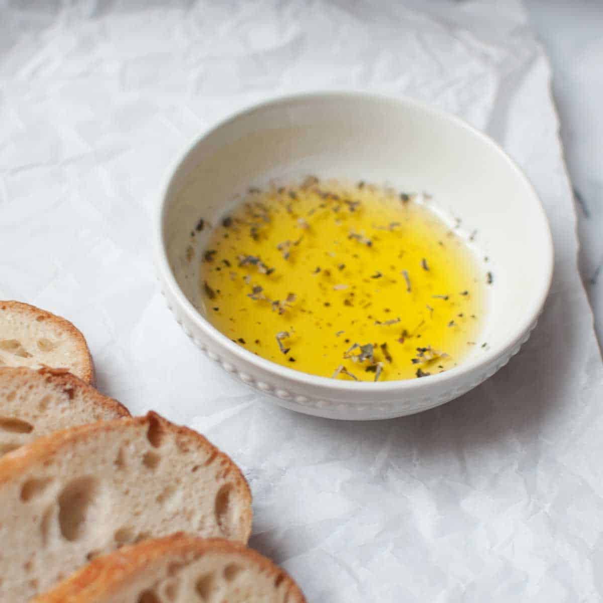 olive oil dip (olive oil and spices) in a small white bowl
