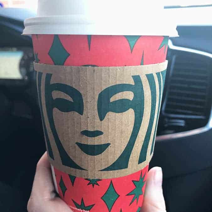 Hot starbucks drink being held by a hand