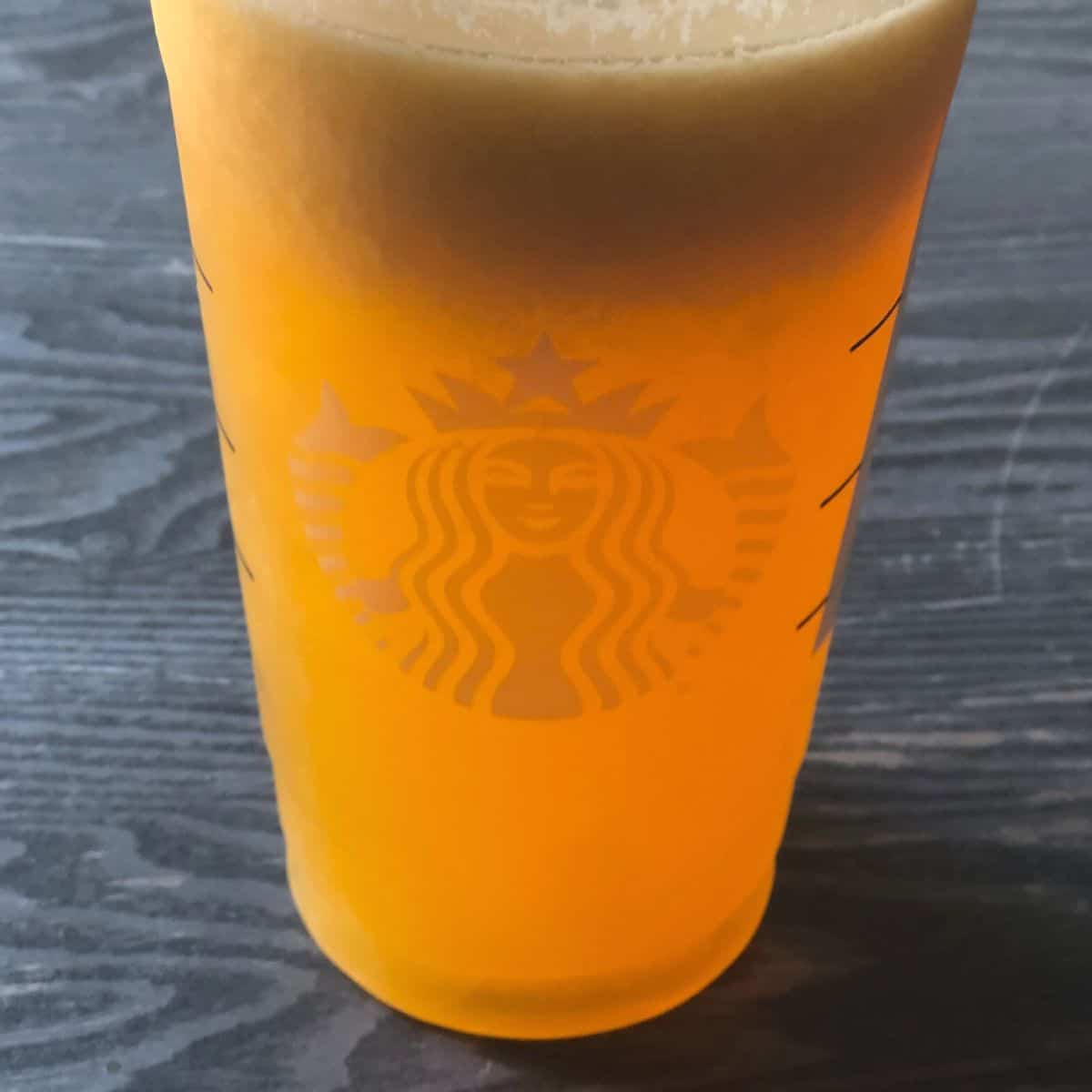 A dark yellow Starbucks cold drink