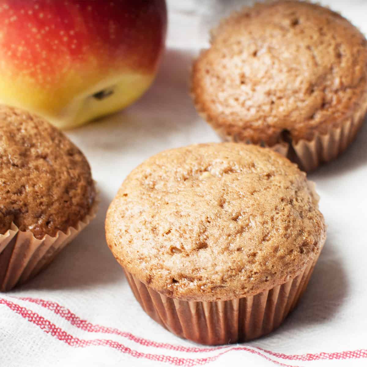 sourdough apple muffins and a red apple
