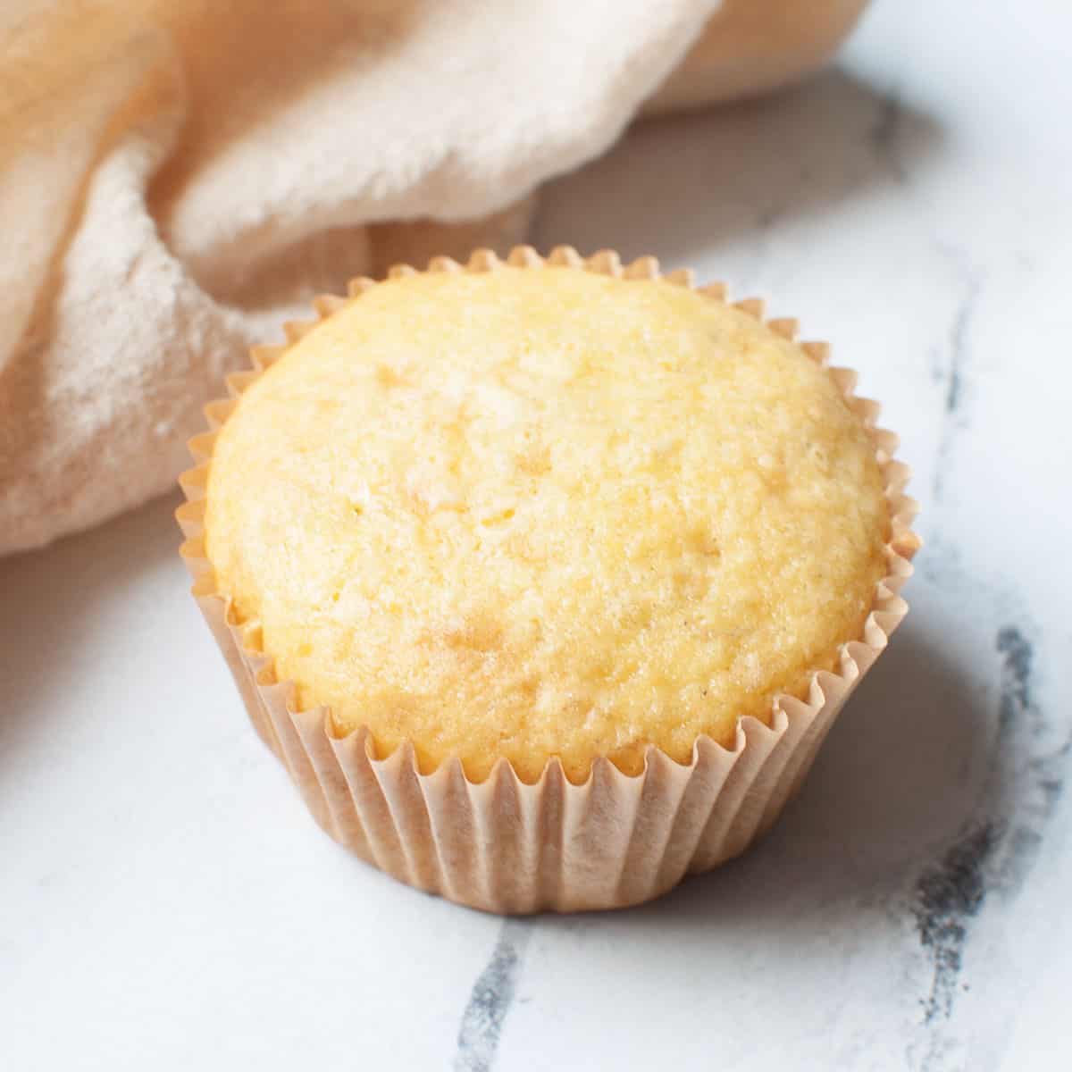 cake mix banana muffin with a linen in the background