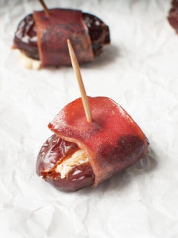 Turkey bacon wrapped date with a toothpick in it.