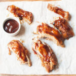 Ribs with a bowl of barbecue sauce.