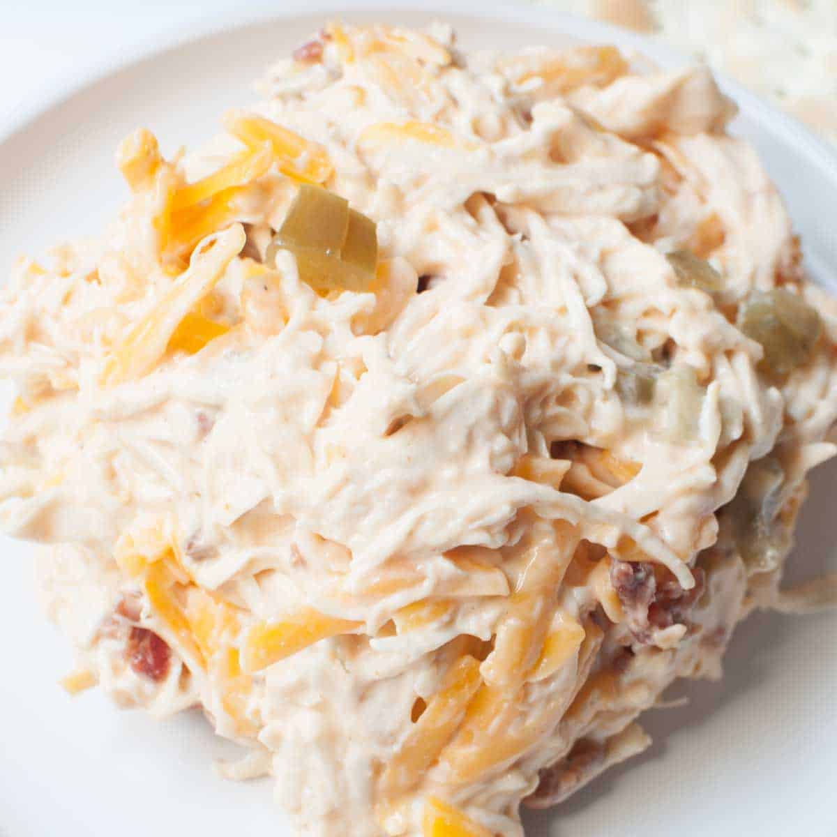 An upclose view of copycat Chicken Salad Chick Kickin Kay Lynne chicken salad (chicken salad with bacon, cheddar, and pickled jalapenos in it).