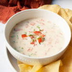 Close up view of Copycat Freebirds Queso. There are tortilla chips around the bowl.