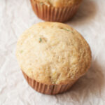 Sourdough zucchini muffin on a white background.