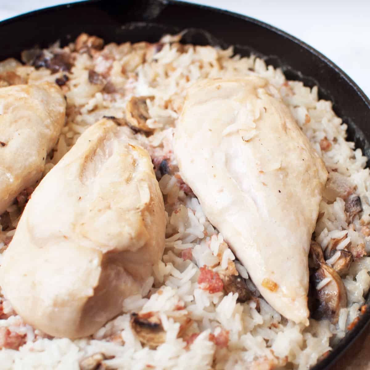 Chicken and rice in a cast iron skillet.