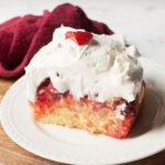 A slice of Carrabba's Dessert Rosa Cake with a red linen behind it.