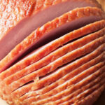 An upclose image of Amish baked ham that has been sliced.