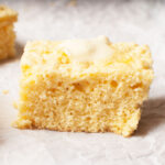 A slice of cornbread with butter on top.