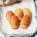 Copycat Starbucks Madeleine cookies on a silver tray with white parchment paper.