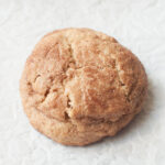A close up photograph of a jumbo snickerdoodle.
