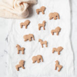 Cinnamon animal crackers on a light marble background.