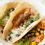 An up close photo of copycat Torchy's Tacos Mr. Orange tacos on a plate.
