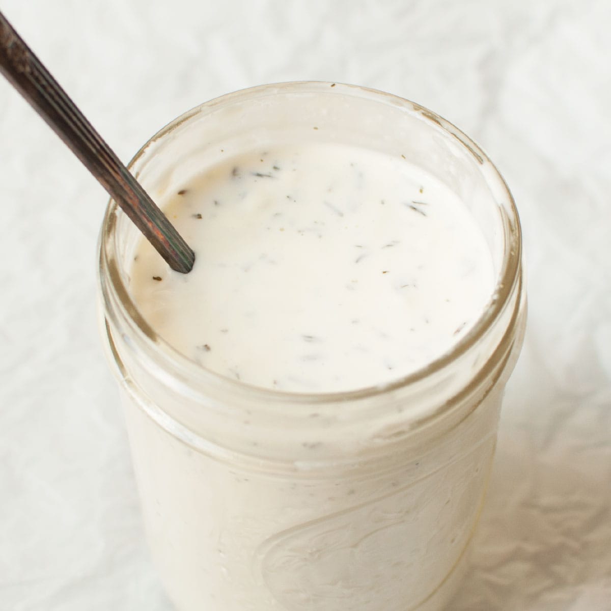 Copycat Salata ranch in a mason jar with a small spoon.