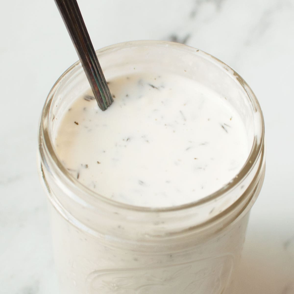 Copycat Salata ranch in a mason jar with a small spoon.