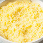 An up close photograph of Copycat Cava Saffron Rice in a white bowl.