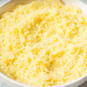 An up close photograph of Copycat Cava Saffron Rice in a white bowl.