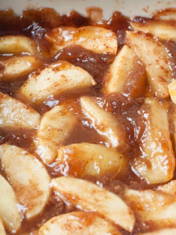 An up close photo of copycat Boston Market Cinnamon Apples in a white casserole dish.