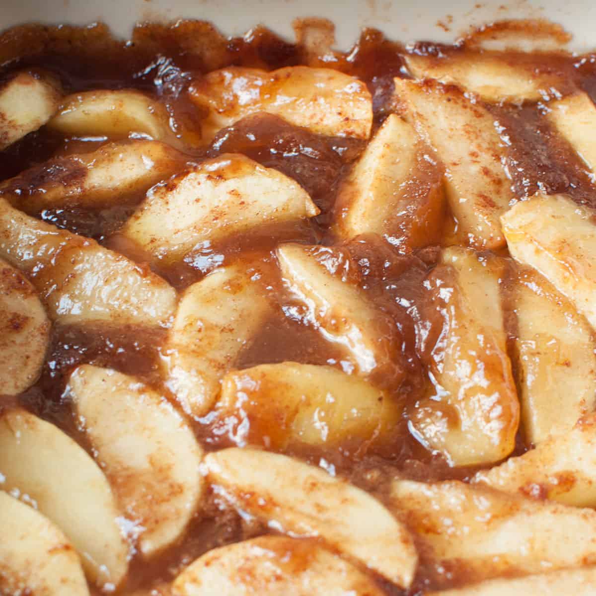 An up close photo of copycat Boston Market Cinnamon Apples in a white casserole dish.