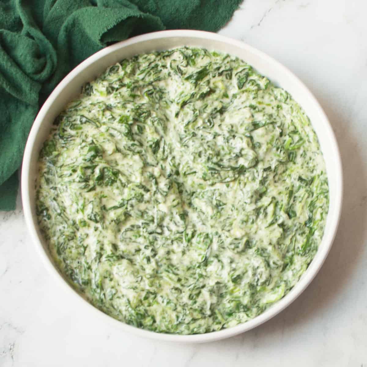 Copycat Boston Market Creamed Spinach in a white bowl.