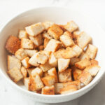 Copycat Texas Roadhouse croutons in a white bowl on a marble background.