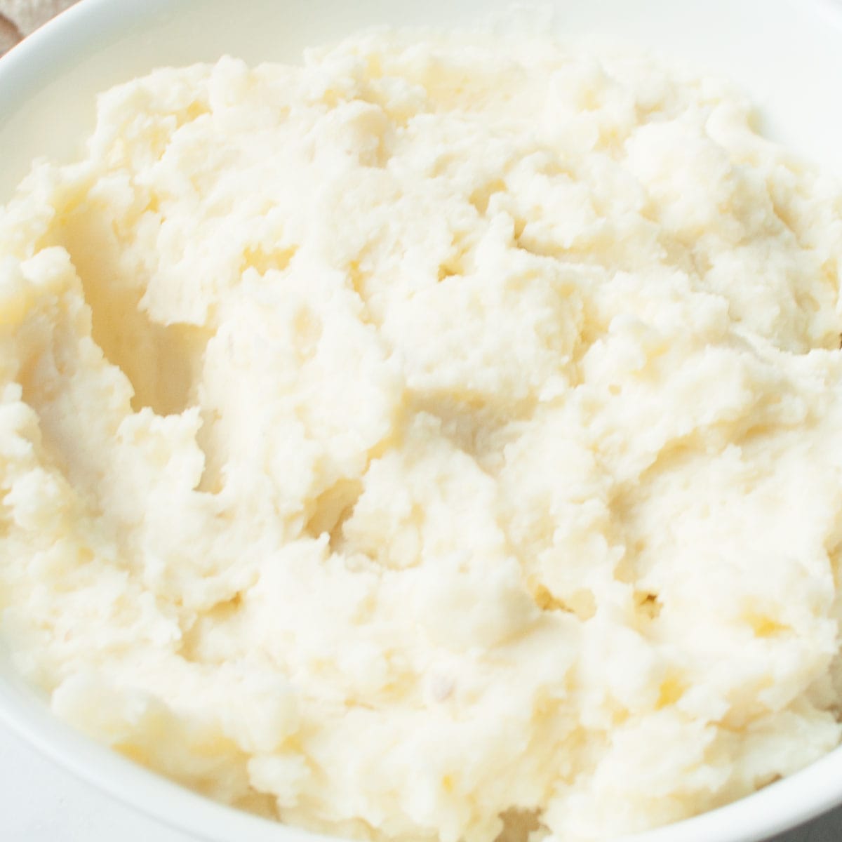 Copycat Texas Roadhouse Mashed Potatoes in a white bowl.