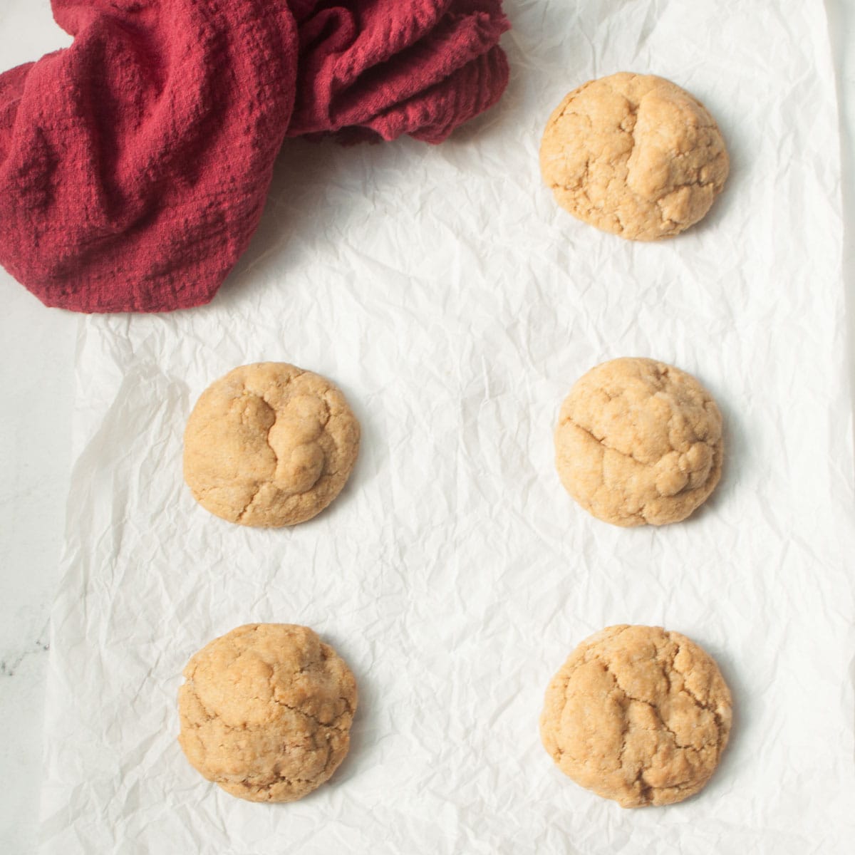 Soft ginger cookies on a white background with a red linen.