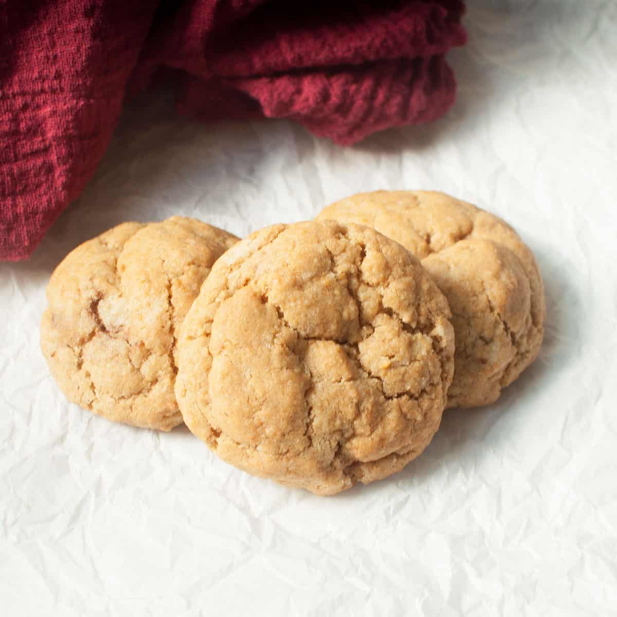 Soft ginger cookies on a white background with a red linen.